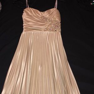 A champagne colored formal dress